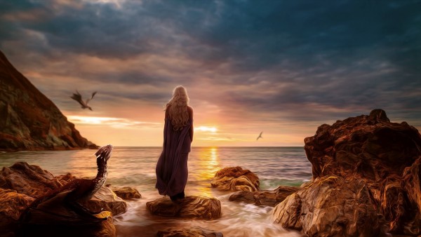 Обои с девушкой стоящей на камнях у моря рядом с драконами